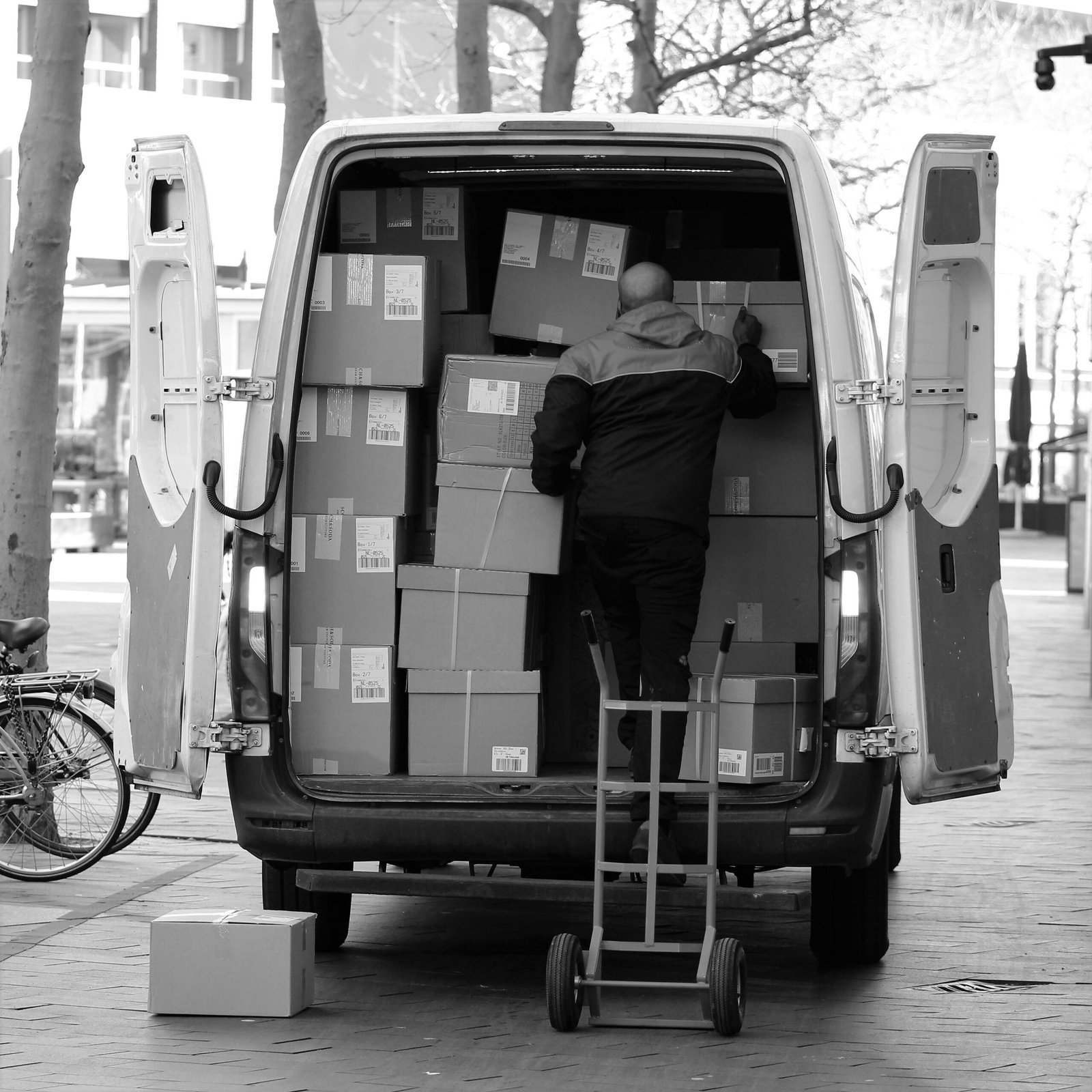 A Man Arranging Packages in a Van